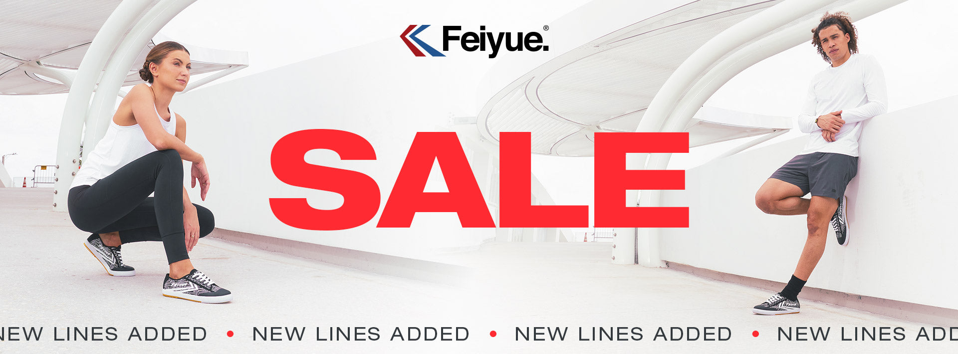 Two people in a modern outdoor setting, featuring the Feiyue logo and 'Sale: New Lines Added' text.